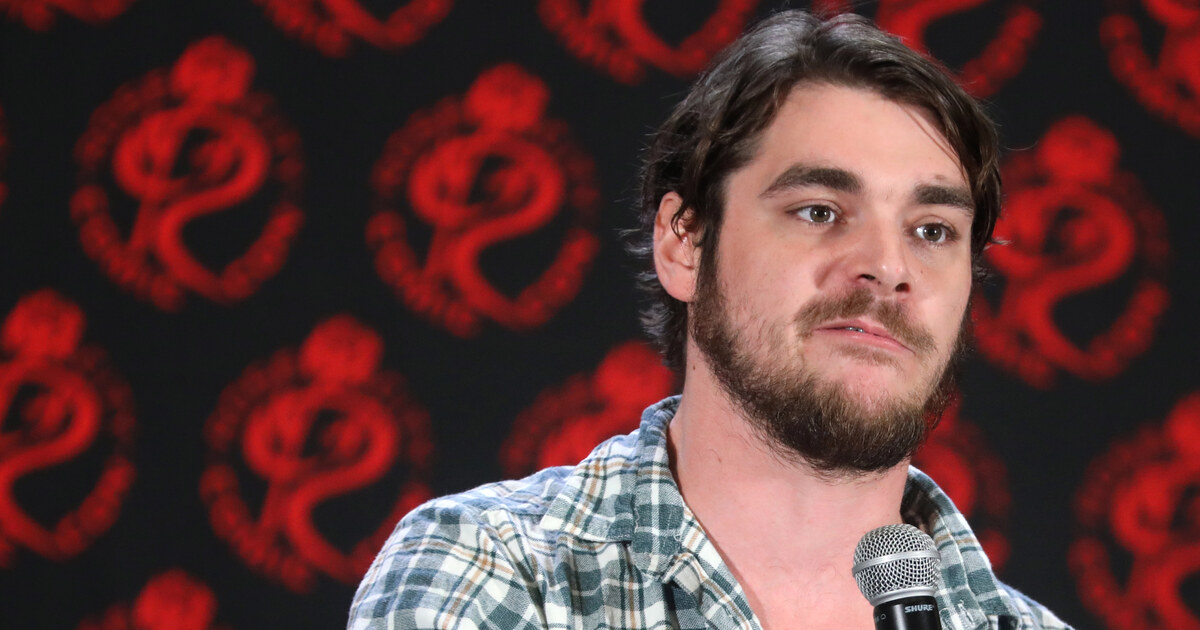 Actor RJ Mitte speaking into a microphone at Rose City Comic Con in 2024