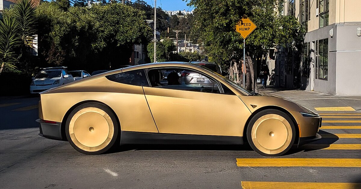 A gold Tesla Cybercab on a San Francisco street in June 2026